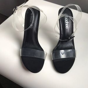 Boohoo black heels with clear straps.